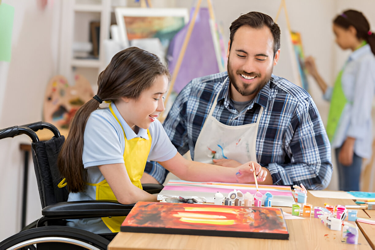 Art teacher providing individual instruction to a student.